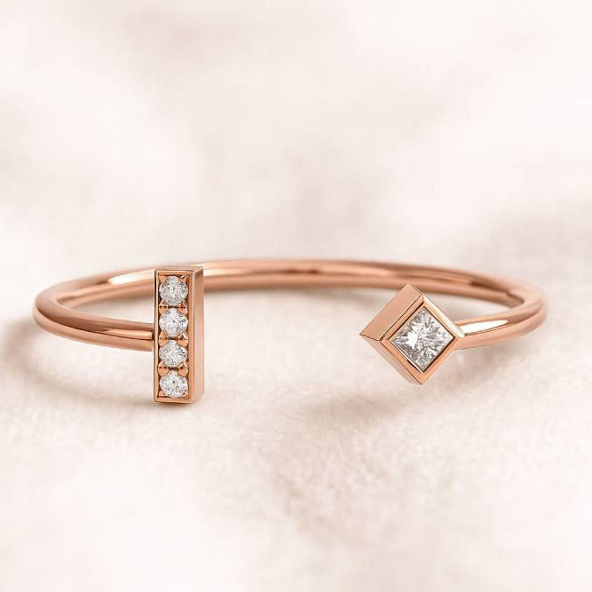 Rose gold ring with diamond accents on a light pink background