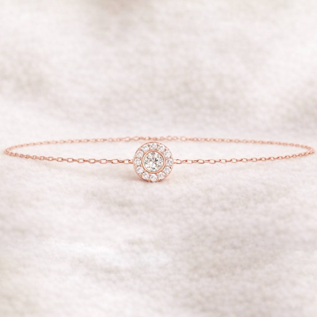 Rose gold bracelet with a diamond on a light background