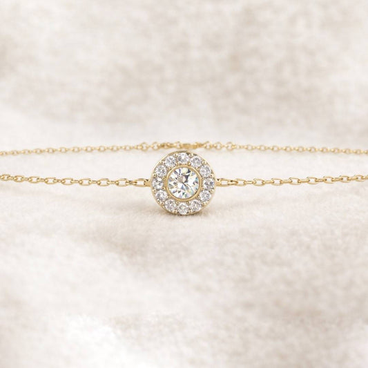 Gold bracelet with a diamond on a soft beige background