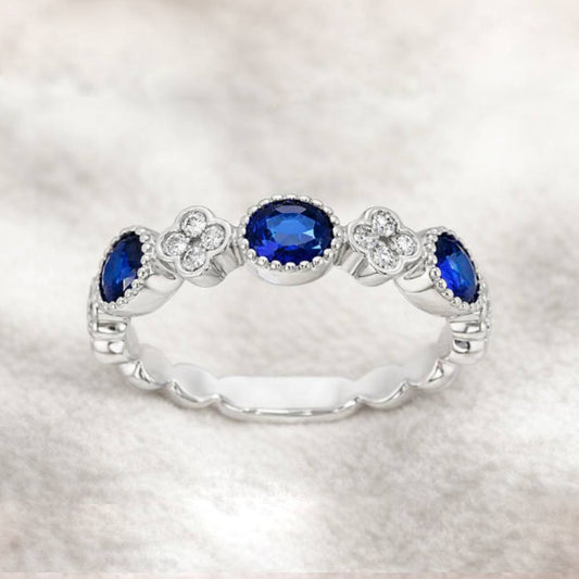 gold ring with blue gemstones on a white background