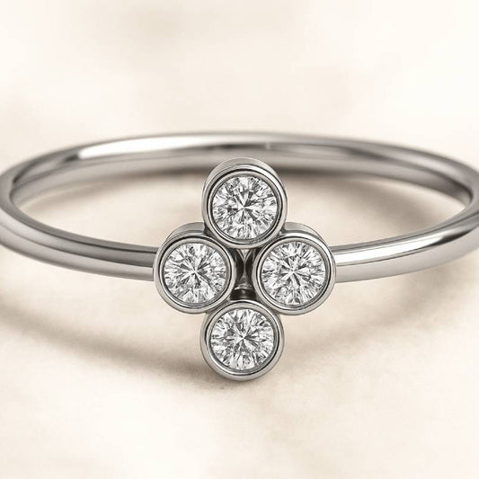 ring with four diamond stones on a beige background