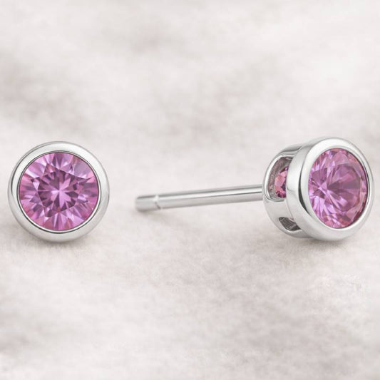 Pink gemstone stud earrings on a light gray background