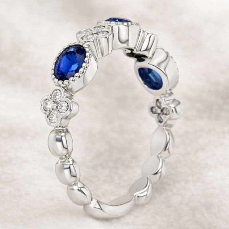 gold ring with blue gemstones on a light gray background