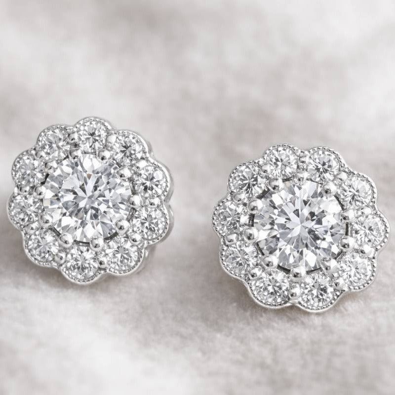 Pair of diamond earrings on a soft gray background