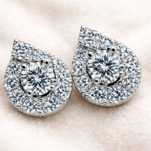 Pair of diamond earrings with a smiley face design on a light background
