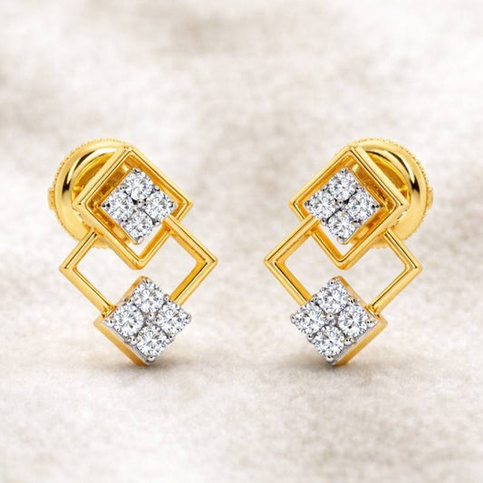 Gold earrings with diamond accents on a beige background
