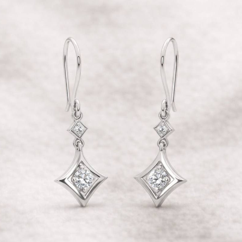 Pair of diamond earrings on a light gray background