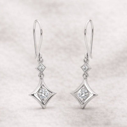 Pair of diamond earrings on a light gray background