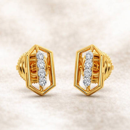 Gold earrings with diamond accents on a beige background