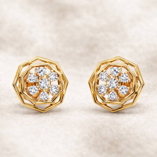 Gold earrings with diamond accents on a beige background