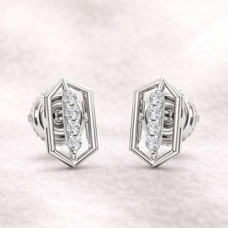 Pair of earrings with diamond-like stones on a light gray background