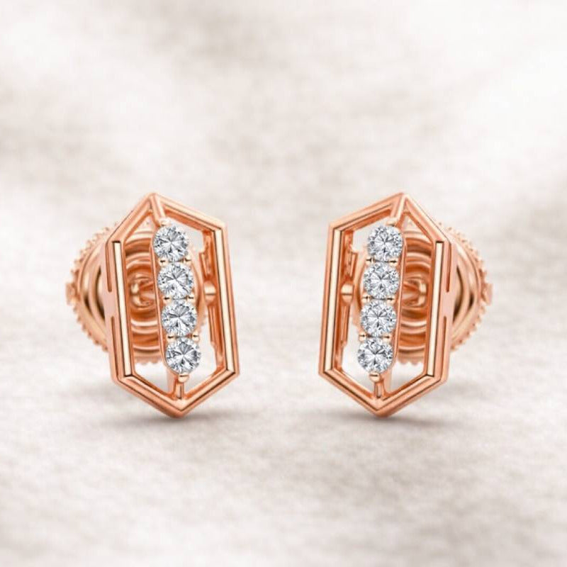 Rose gold earrings with diamond accents on a soft beige background