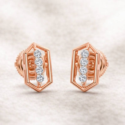 Rose gold earrings with diamond accents on a soft beige background