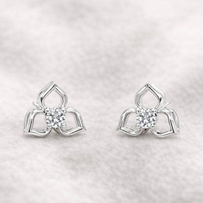 Pair of earrings with a diamond on a light gray background
