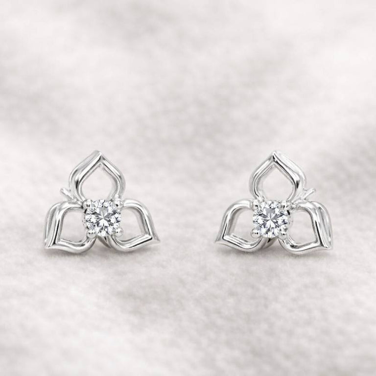 Pair of earrings with a diamond on a light gray background