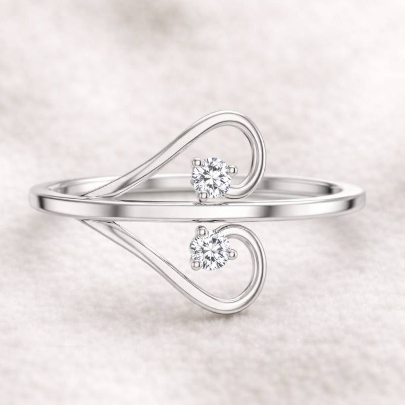  ring with two diamonds on a light background