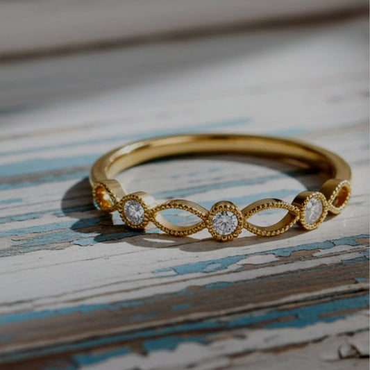 Gold ring with diamond accents on a textured wooden surface