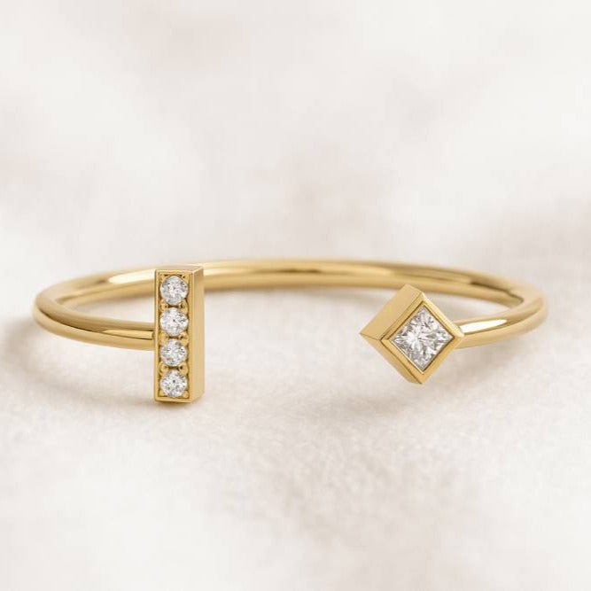 Gold ring with diamond accents on a light background