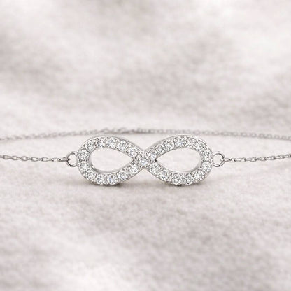 infinity bracelet on a light gray background