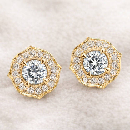Pair of gold and diamond earrings on a light background