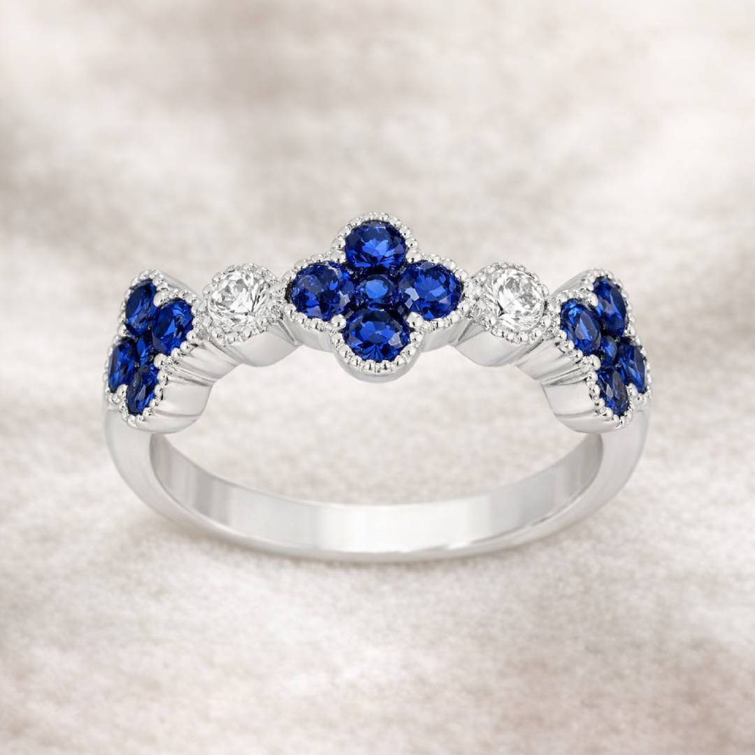 Gold ring with blue gemstones on a light background