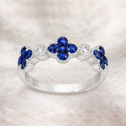 Gold ring with blue gemstones on a light background