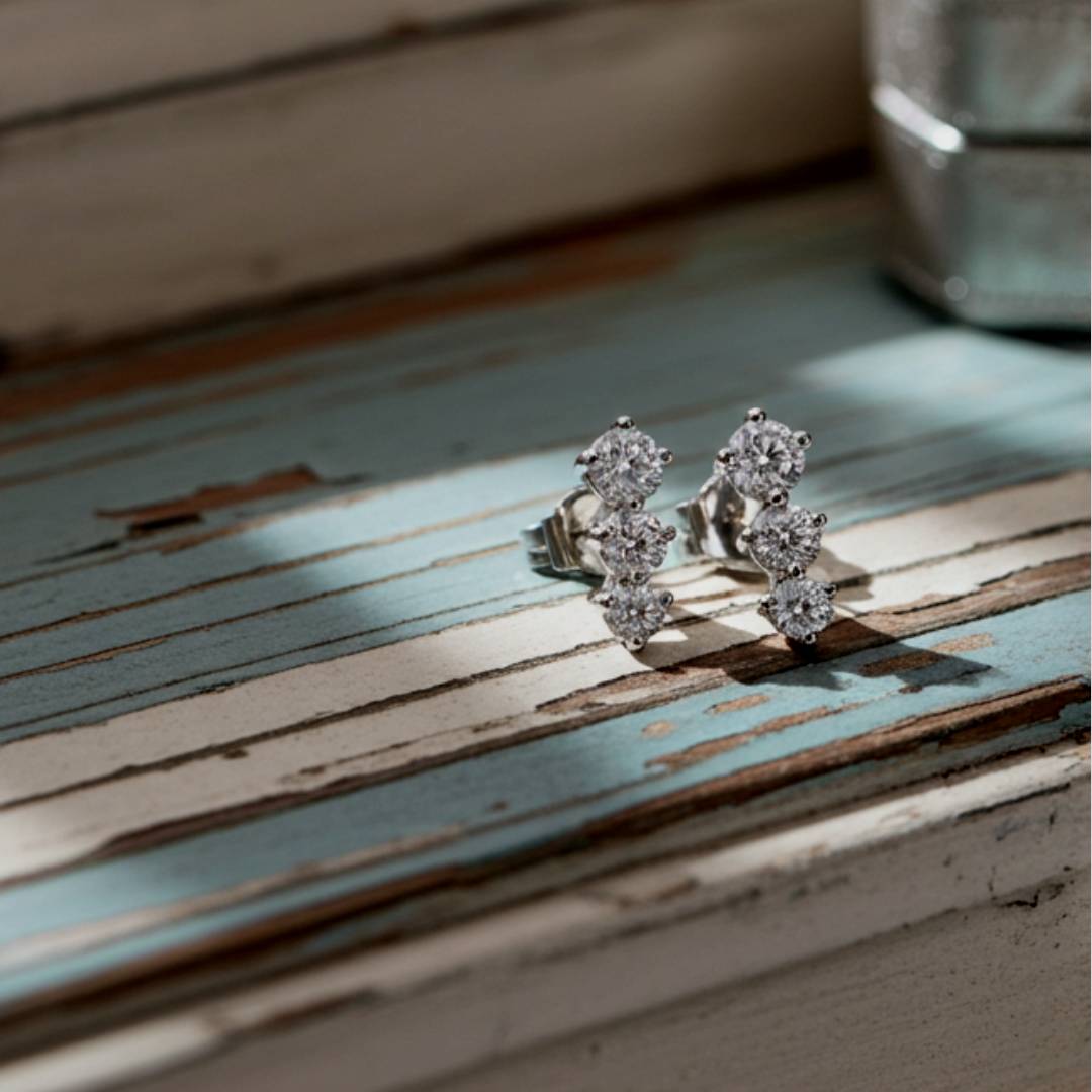 earrings with clear stones on a rustic wooden surface