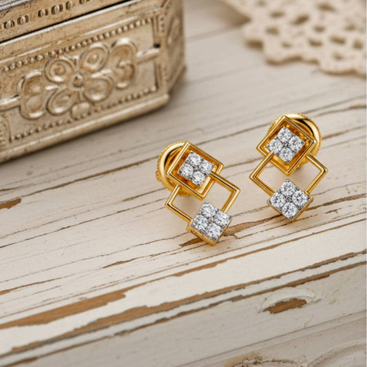 Gold earrings with diamond accents on a wooden surface