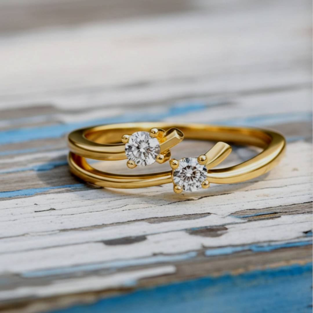 Gold ring with two diamond stones on a wooden surface