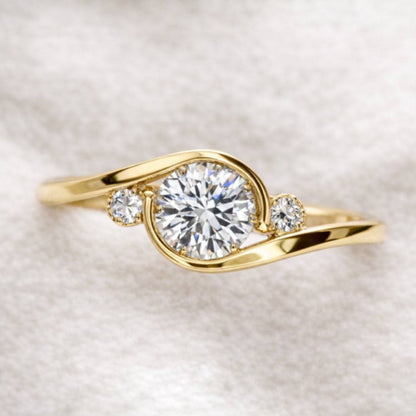 Gold ring with a large diamond and smaller diamonds on a textured beige background