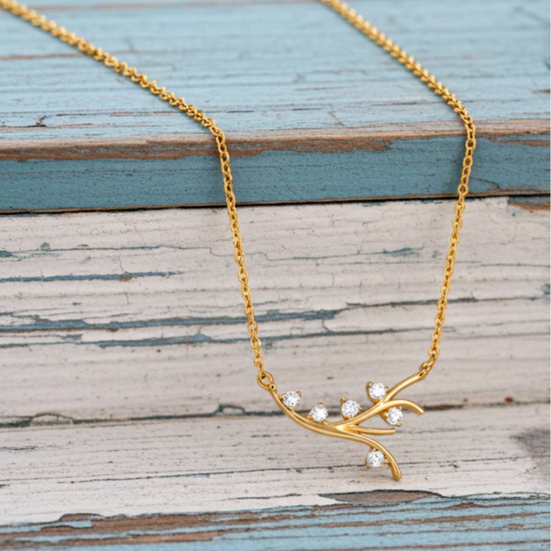 Gold necklace with diamond-like stones on a wooden surface