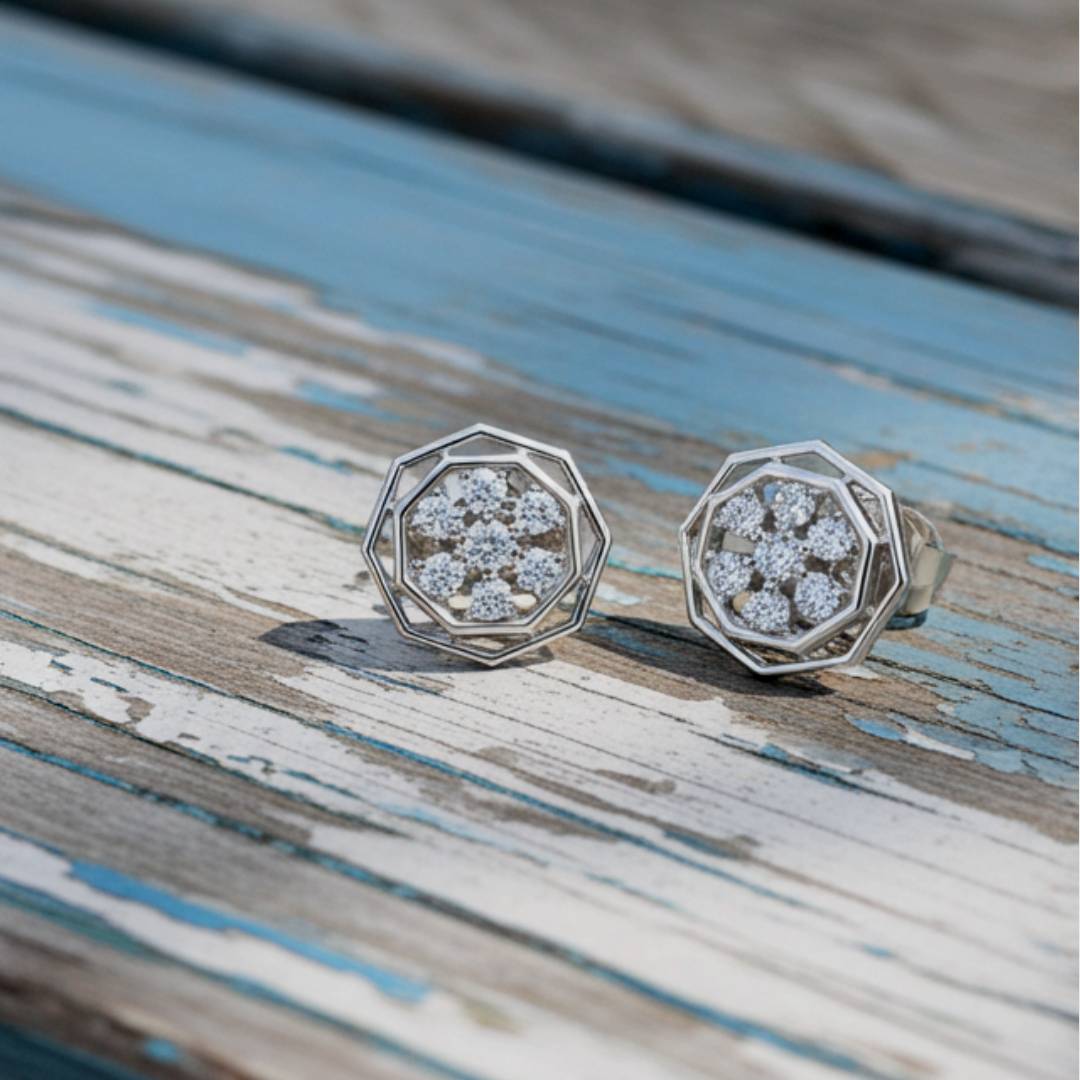 hexagonal earrings with gemstones on a wooden surface
