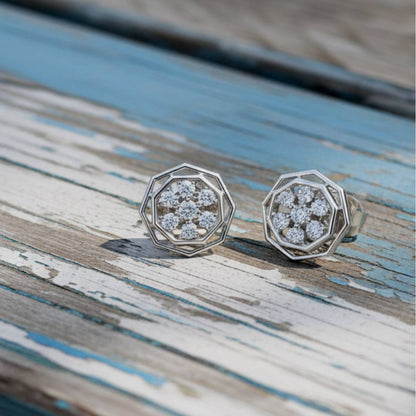 hexagonal earrings with gemstones on a wooden surface