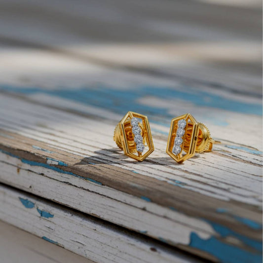 Gold earrings with diamond accents on a wooden surface