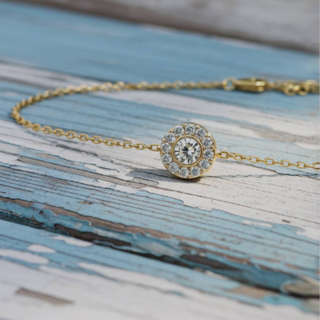 Gold bracelet with a diamond-like stone on a wooden surface
