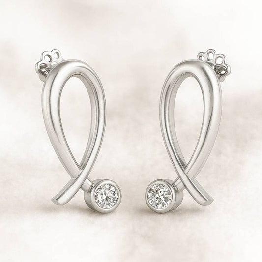 Pair of earrings with round gemstones on a light background