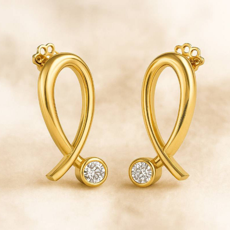 Gold earrings with round gemstones on a beige background