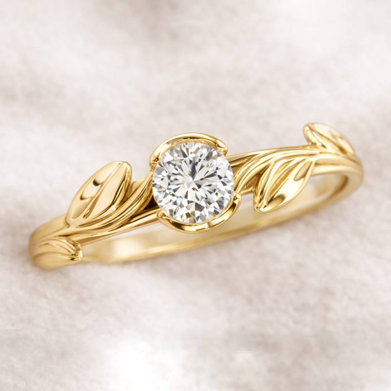 Gold ring with a diamond on a soft beige background
