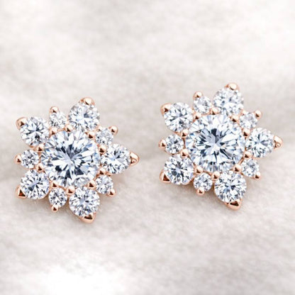 Rose gold and diamond earrings on a light background