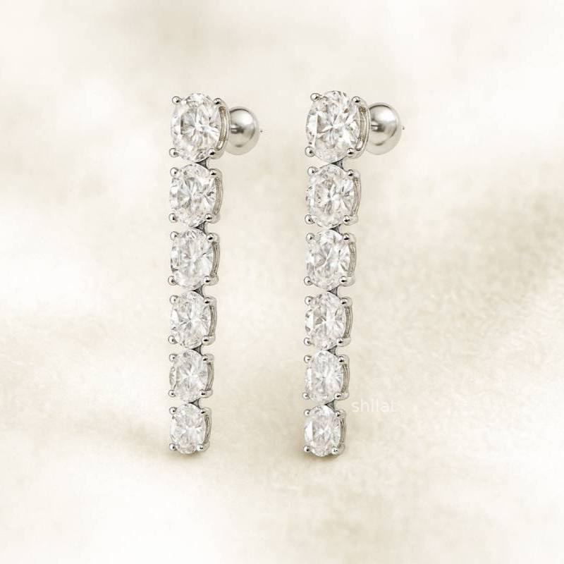 Pair of diamond earrings on a light background