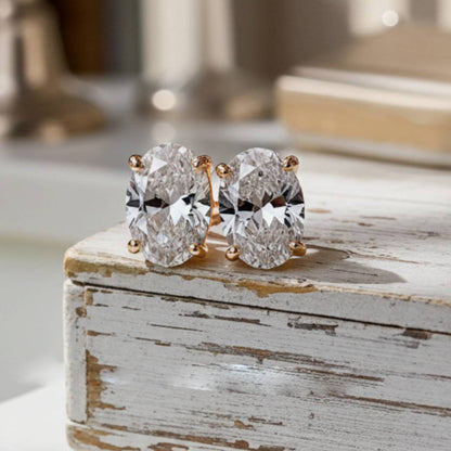 Pair of diamond earrings on a rustic wooden surface