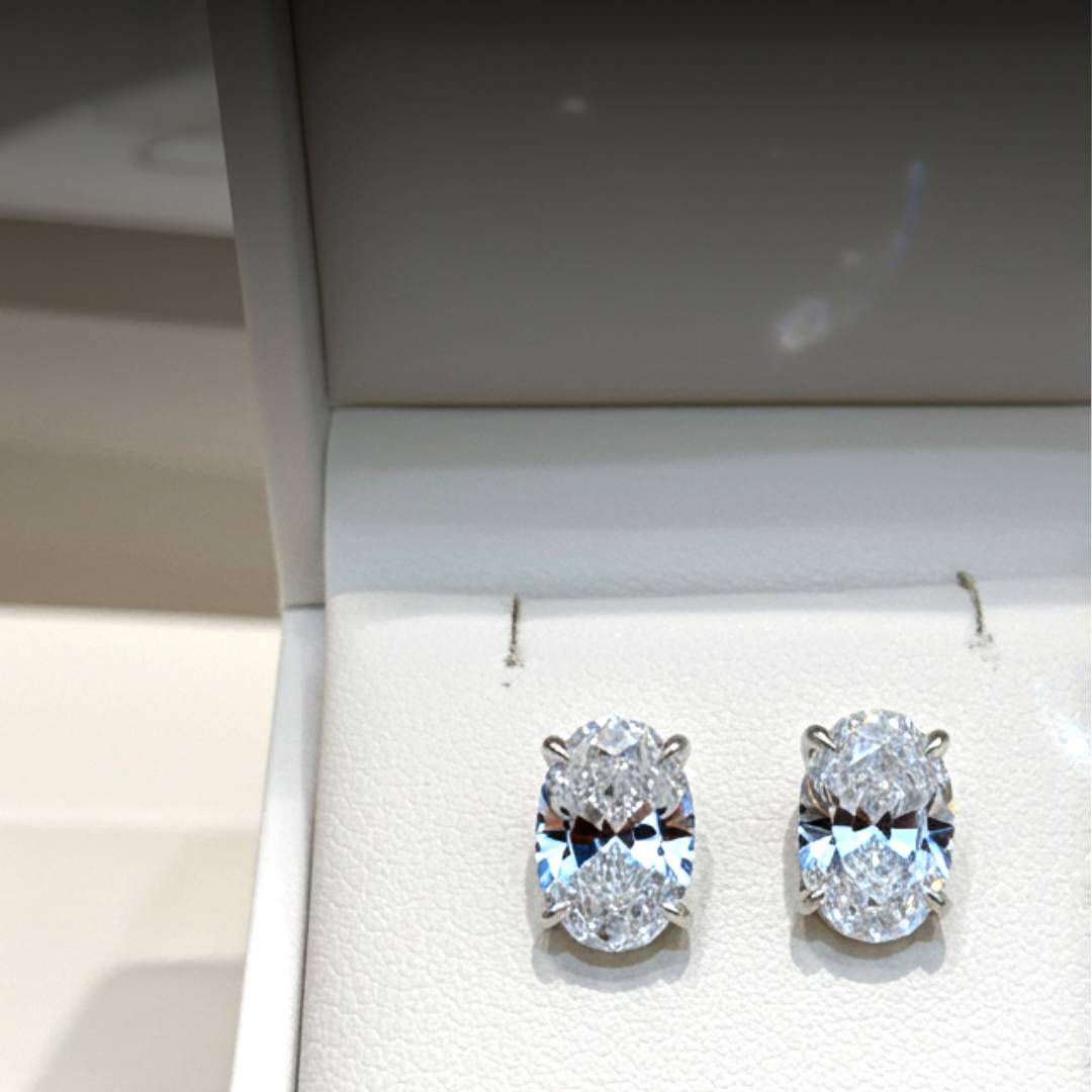 Diamond earrings in a jewelry box on a light background