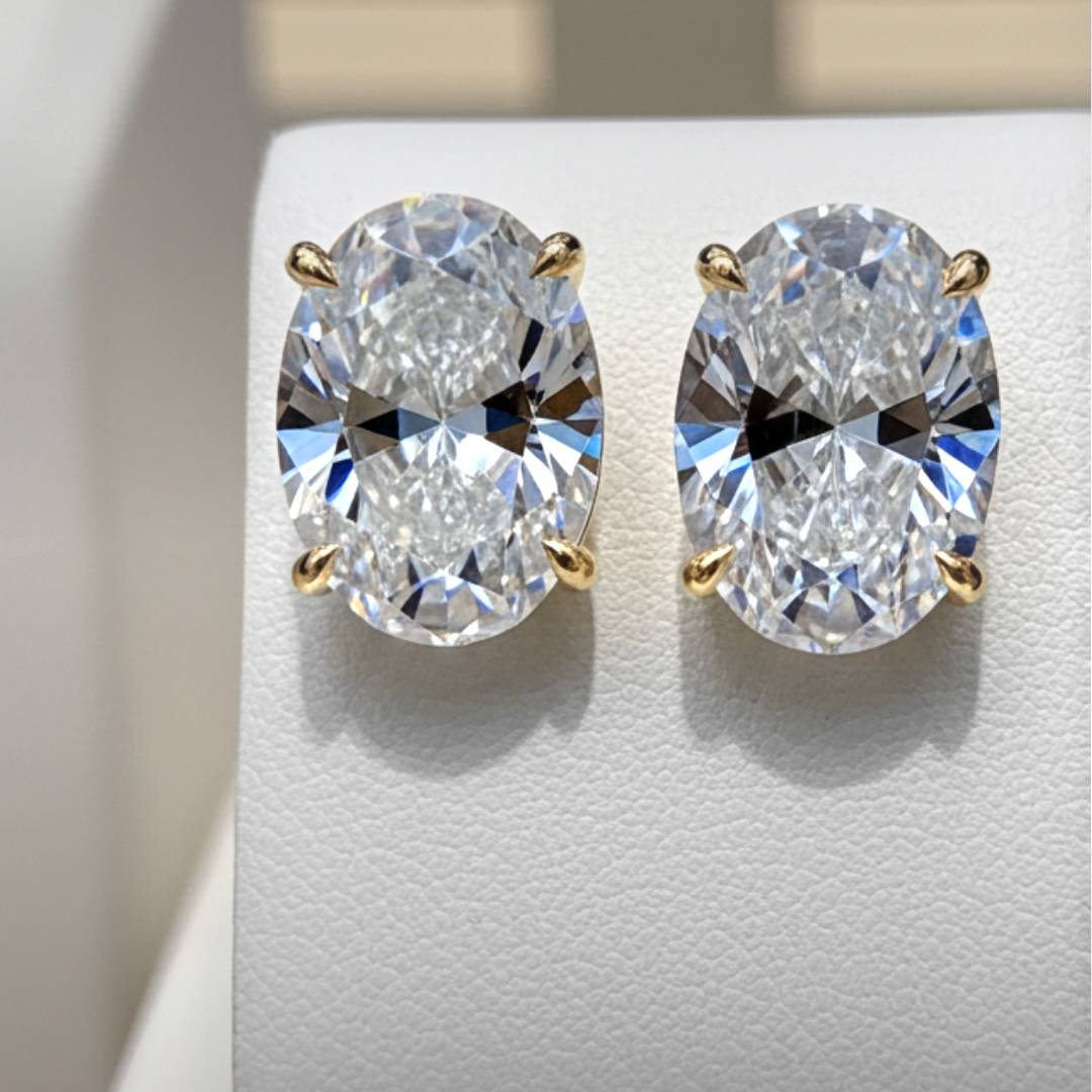 Pair of diamond earrings on a light gray background