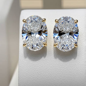 Pair of diamond earrings on a light gray background