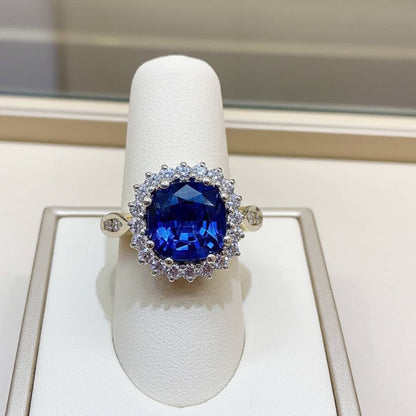 Ring with a blue gemstone on a white stand