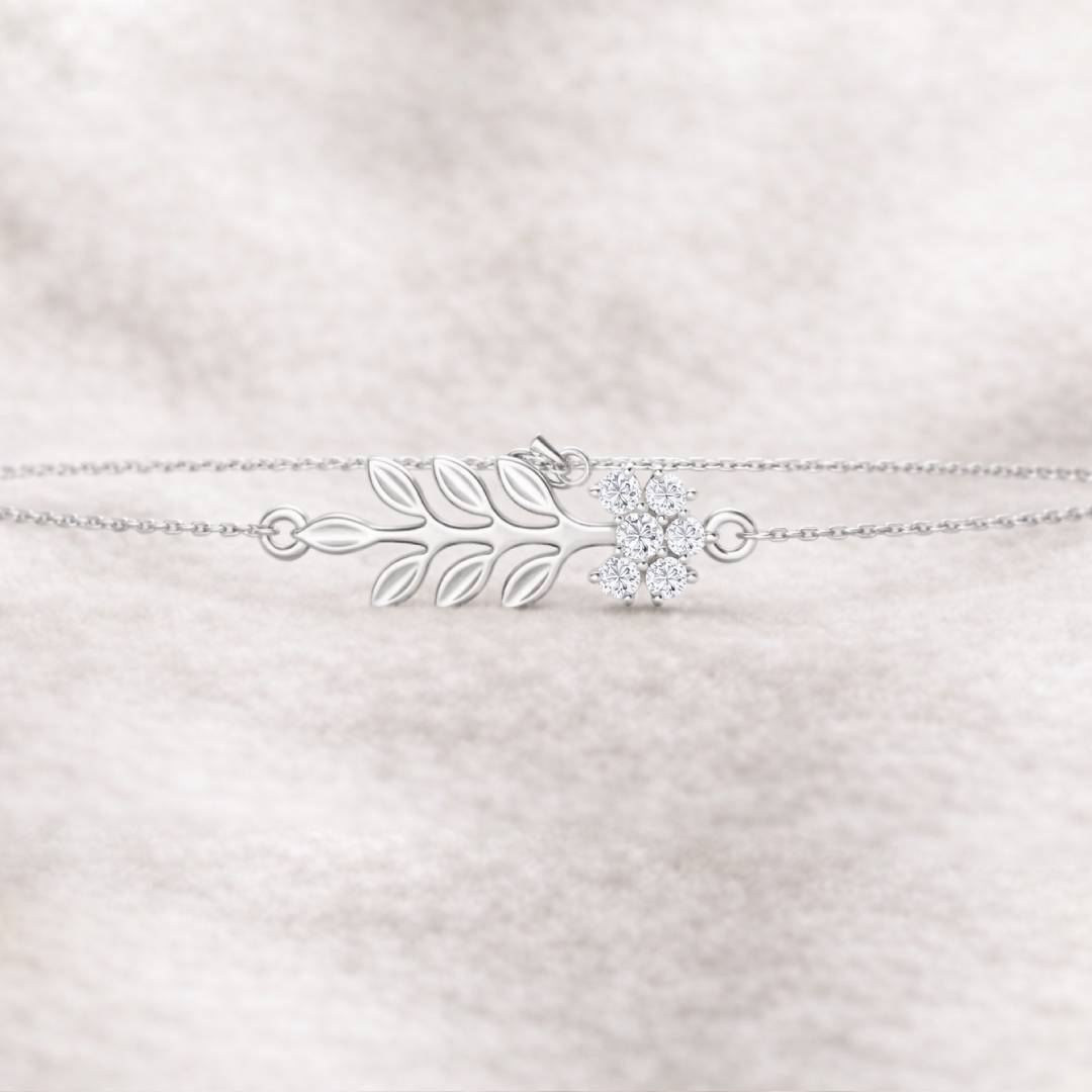 bracelet with leaf design and clear gemstone on a light pink textured background