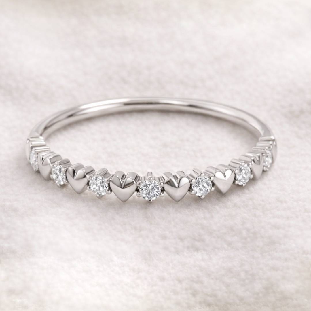 ring with heart and diamond designs on a light gray background