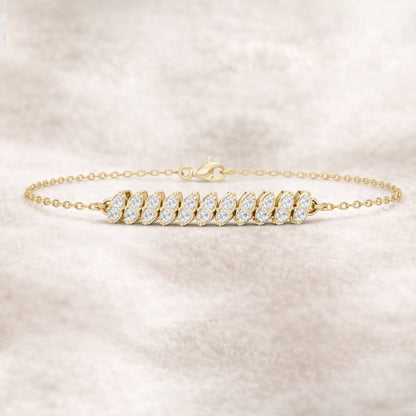 Gold bracelet with clear stones on a light beige background