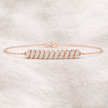 Rose gold bracelet with clear stones on a light beige background