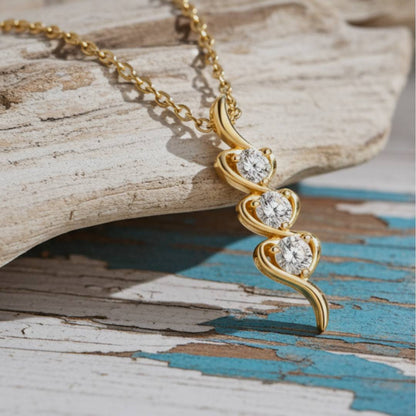 Gold necklace with a heart-shaped pendant on a wooden surface